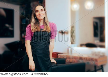 Happy Hairdresser Standing Next To An Empty Chair In A Salon