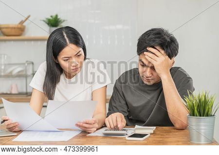 Stressed Asian Young Couple Family, Wife And Husband Confused By Calculate Expense From Invoice Or B