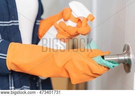 Hand Of Asian Young Woman, Girl Cleaning Rubs Dust, Use Rags, Spray Bottle On Knob Door Of Toilet Ro