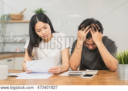 Stressed Asian Young Couple Family, Wife And Husband Confused By Calculate Expense From Invoice Or B