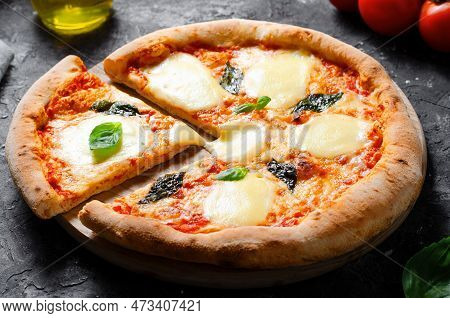 Italian Pizza Margherita With Mozzarella Cheese And Basil Leaves On Dark Background, Freshly Baked P