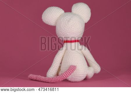 Amigurumi One White Mouse With Big Ears And Long Nose On A Pink Background. Rear View. A Soft Diy To
