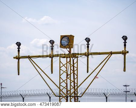 Yellow Metal Support Systems Of Care During Takeoff And Landing Direction Light Near Runway.