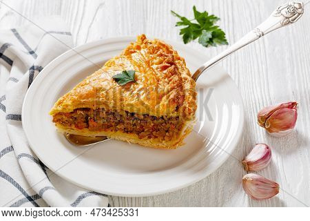 Slice Of  Ground Beef Meat Pie With A Flaky Puff Pastry Double Crust With Hearty Minced Beef Cooked 
