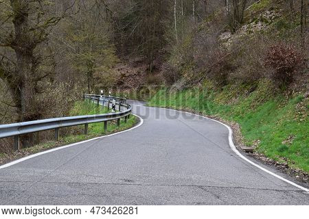 Winding Narrow Country Road In Rural Winter Forest