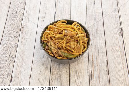 Bowl Of Sauteed Noodles With Mushrooms, Boletus And Vegetables, Peppers And Onions With Soy Sauce On