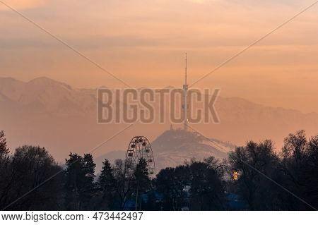 Almaty, Kazakhstan - January 07, 2023: Winter Sunset View From City Park To Koktobe Mountain With Tv