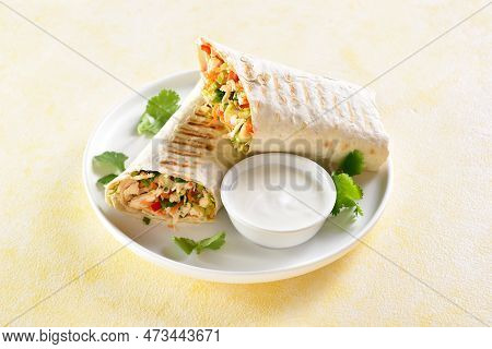 Tortilla Wraps With Chicken Meat And Fresh Vegetables On Plate Over Light Background. Close Up View