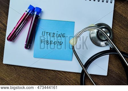 Concept Of Uterine Fibroid Write On Sticky Notes With Stethoscope And Blood Sample Isolated On Woode
