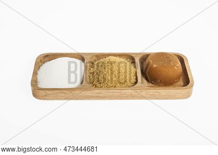 White Sugar, Brown Sugar And Sugar Cane Panela On White Background