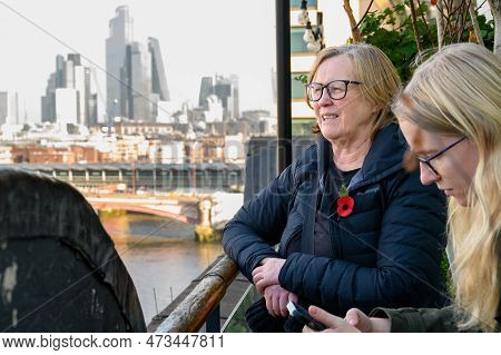 Two Women Are Taking In The Breathtaking View Of The London Skyline From The Oxo Tower Observation D