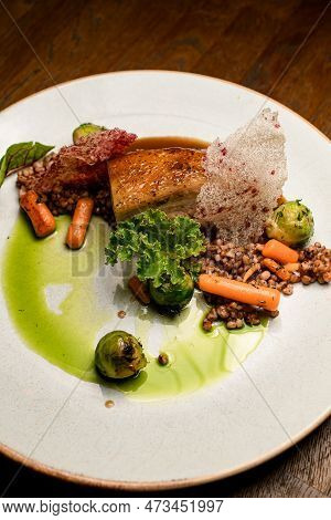 View On Plate With Dish Of Piece Of Baked Pork Meat With Buckwheat And Vegetables
