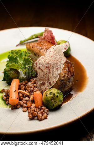 View On Dish Of Appetizing Piece Of Baked Meat With Buckwheat And Vegetables On Plate