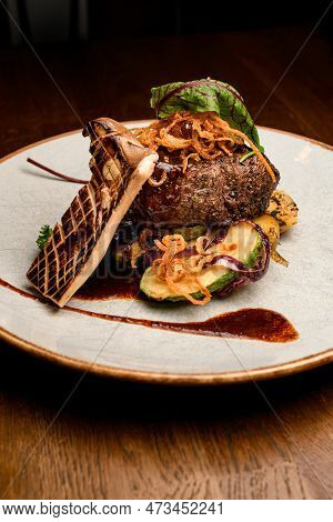 Close-up Of Tasty Dish With Slice Of Grilled King Oyster Mushroom And Piece Of Fried Meat With Potat