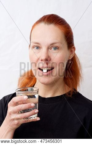 Portrait Of Middle Aged Woman With Herpes Above Upper Lip, On Light Background. Woman Holding Glass 
