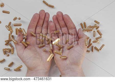 Guarana Capsules In Male Hands On A White Background. Flying Guarana Capsules.natural Tonic.alternat