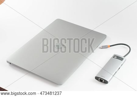 Ivano-frankivsk, Ukraine, January 28, 2023: Apple Macbook With Adapter, Copy Space And White Backgro