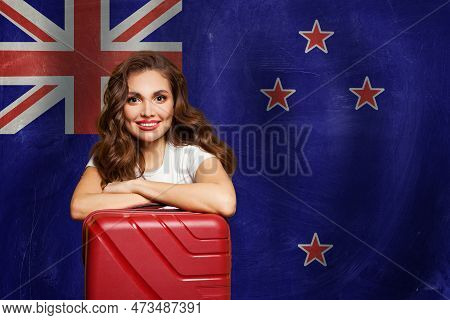 Travel In New Zealand Concept. Happy Woman With Suitcase On Flag Of New Zeland. Welcome To New Zelan