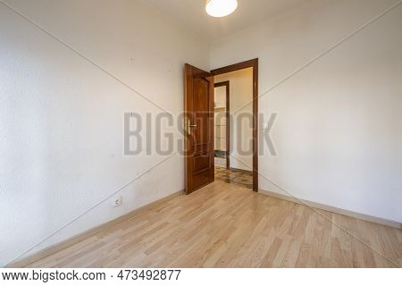 Small Empty Room With Laminated Flooring And Sapele Wood Access Door