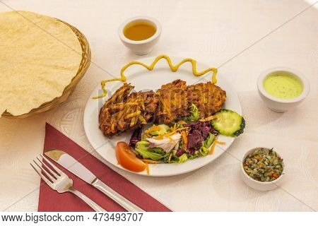Vegetable Indian Pakora Of Fried Vegetables Mixed With Chickpea Flour With Lettuce. Naan Bread And C