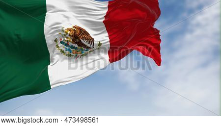 Mexican National Flag Waving In The Wind. Vertical Tricolor Of Green, White, And Red With National C