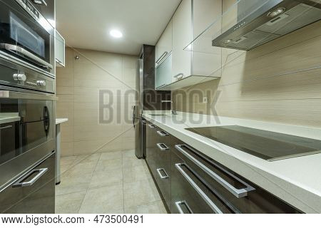 Kitchen With Silestone Countertop With Ceramic Hob With Extractor Hood And Appliances And Cream Colo