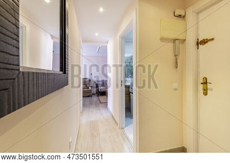 Hall Of A House With Armored Door, Wooden Sideboard And Mirror With Wooden Frame And Doors With Sape