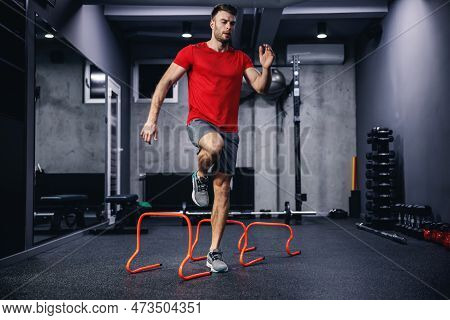 Lateral Skipping Of Small Orange Obstacles And Performing Warm-up Exercises. A Photo Of The Whole Bo