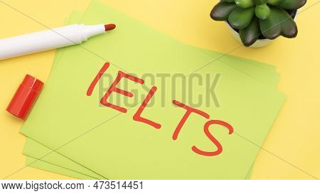 Green Card With Text Ielts On A Yellow Background With Red Marker