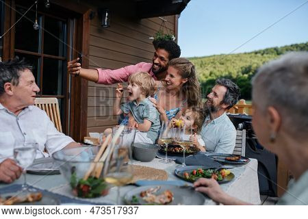 Multigenerational Family Having Bbq Party And Taking Selfie.