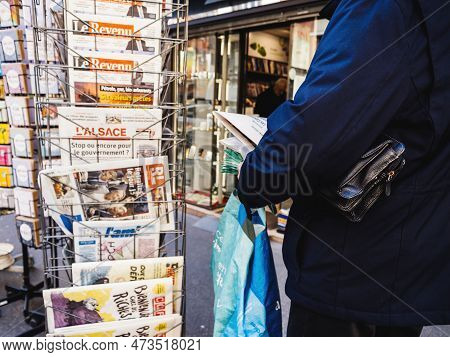 Paris, France - Mar 20, 2023: Senior Buying Press At Kiosk With Multiple French Press Newspaper Feat