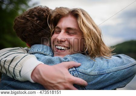 Friends Having Fun Together At Park Lauging And Hugging, Friendship And Lifestyle Concepts