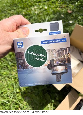 Paris, France - Apr 13, 2022: A Person Unboxing A New Tech Device An Anamorphic Lens, Manufactured B