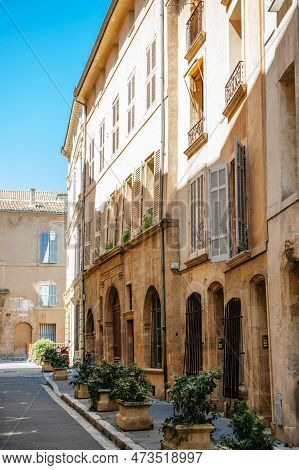A Vibrant Street In Aix-en-provence, France Featuring An Old Church With A Beautiful Half-timbered F