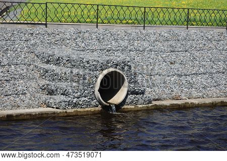 Water Outflows In The River Through Flood Drainage System.
