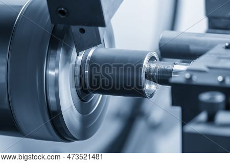 The  Cnc Lathe Machine Boring  Cutting The Metal Shaft Parts. The Hi-technology Metal Working Proces
