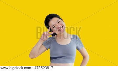 Young Asian Woman Making Two Thumbs Up Gesture Showing Joy And Fun, Symbol Of Good Friendship, Popul