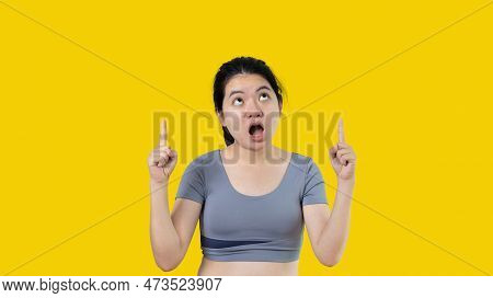 Asian woman pointing finger inviting click here, It is recommended to follow this direction or click