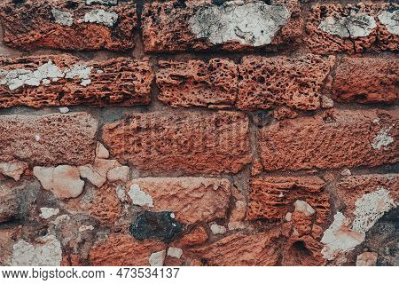 Ancient Brick Red Wall. A Wall Of Old, Cracked Bricks Or Stones, With A Weathered Surface.