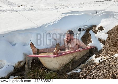 Cold Plunge, Outdoor Cold Water Inmersion In An Old Bathtub Left By A Mountain Spring In The Alps