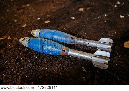 Unexploded Mortar Mines On Ground. War Actions Aftermath