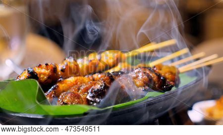 Chicken Satay On Fire With Smoke. Delicious Grilled Chicken Skewers On Bamboo Stick, Roasted On Char