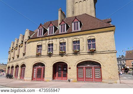 Bergues, France - July 5, 2022: A Traditional House In Bergues With The Belfort In The Background, S