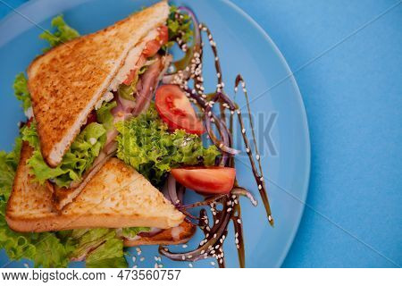 Breakfast Sandwich Toast With Salad. Blue Background. Bread, Beakon Tomatoe On Plate Top View. Meat 