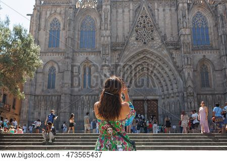 Barcelona, Spain - August 2022: Girl Who Is Taking A Picture To The Cathedral Of The Holy Cross And 