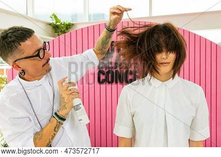 Professional Stylist Working On Young Female Model In Hair Salon