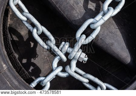 Old Tires And Rubber With Chains And Bindings For Sea Vessels And Tugs, Piled Up, Close-up.