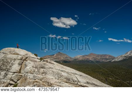 Hiker Taking A Break On The Top Of Lembert Dome In Yosemite