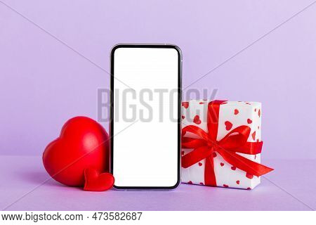 Mobile Phone With Blank Screen On Colored Background With Hearts, Calendar And Gift Box, Valentine D