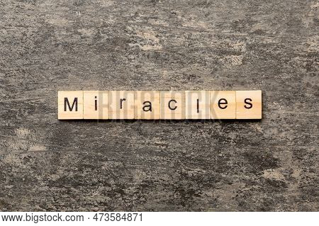 The Miracles Word Written On Wood Block. Miracles Text On Cement Table For Your Desing, Concept.